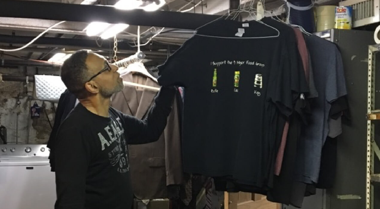 Man looking through racks of clothes